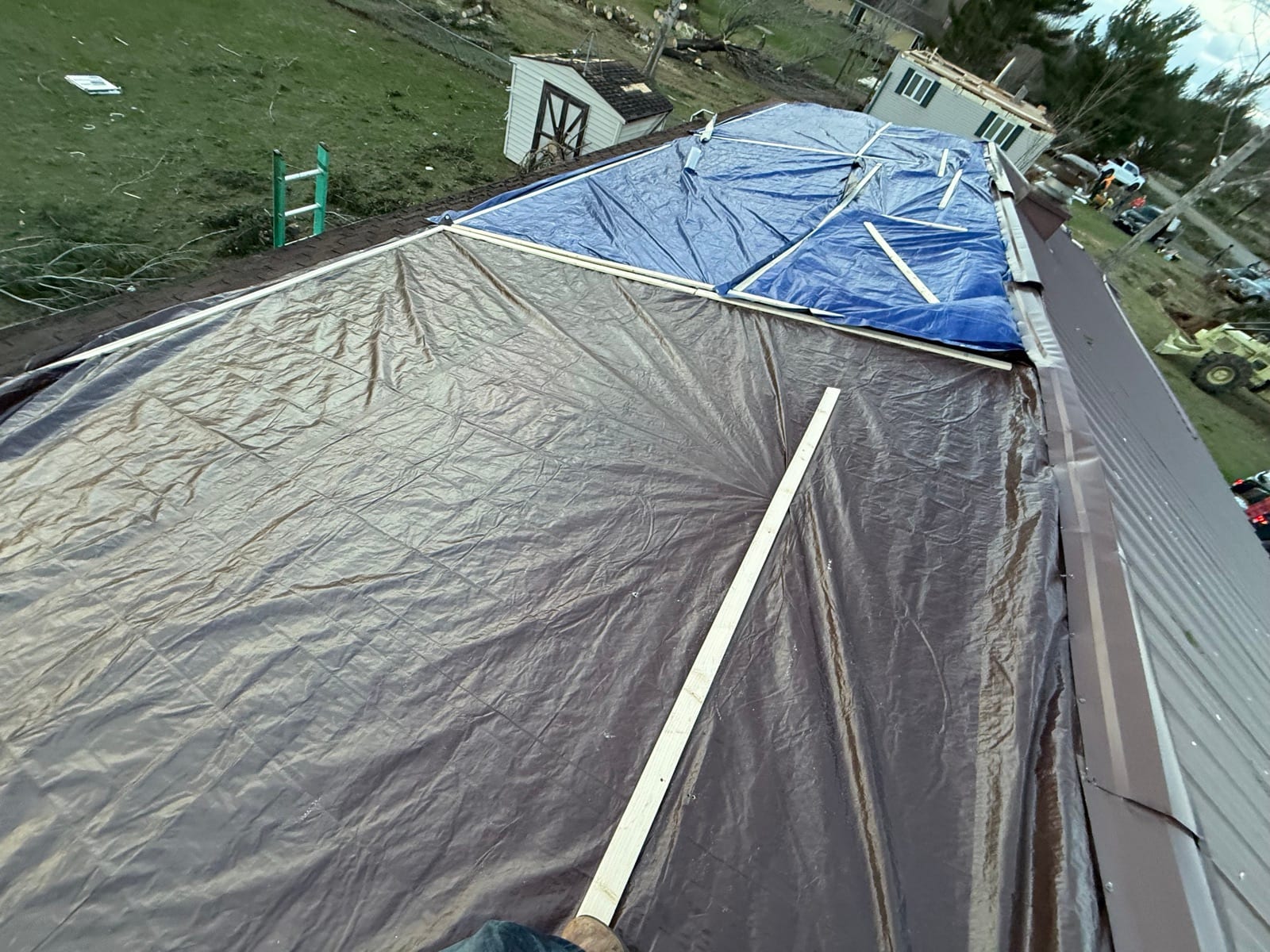 A structure wrapped in protective tarps during restoration.