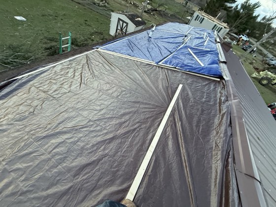 Structure wrapped in tarps to protect it during restoration.
